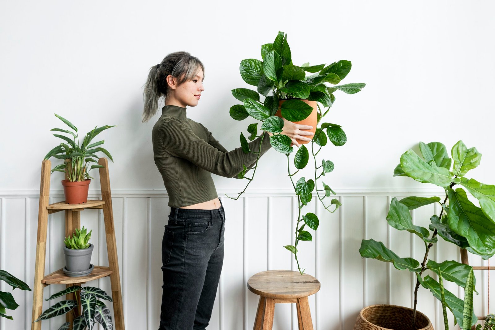 happy-woman-carrying-a-houseplant.jpg